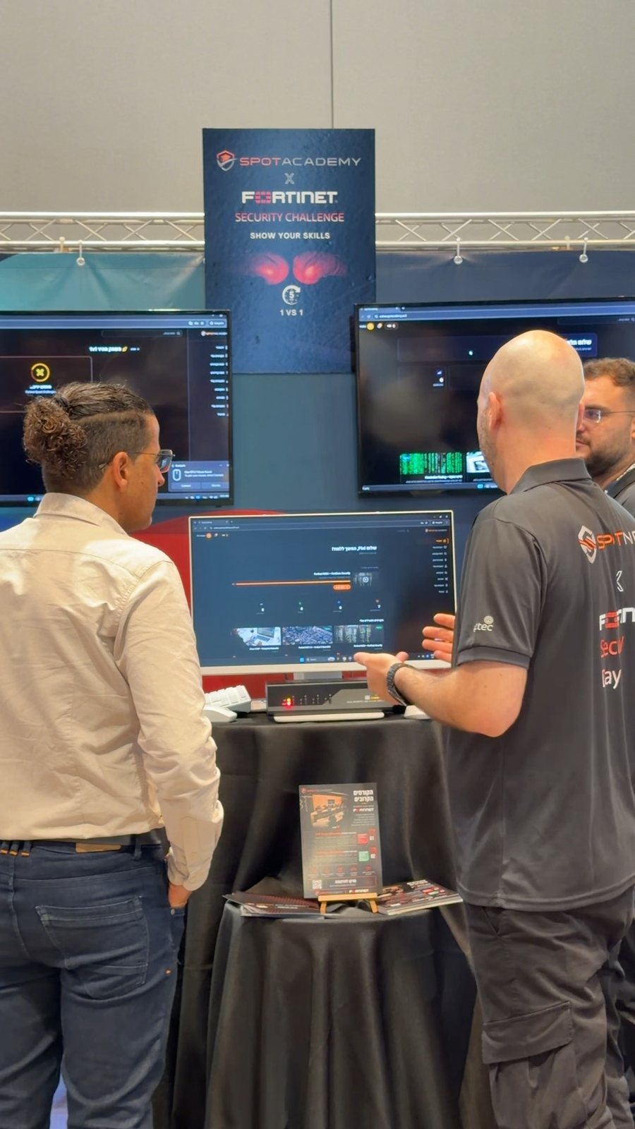Two participants at the SpotAcademy and Fortinet security challenge station